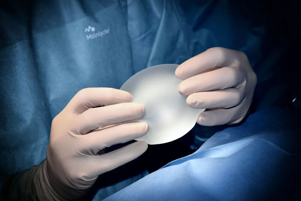 Silicone breast implant held by a surgeon in theatre