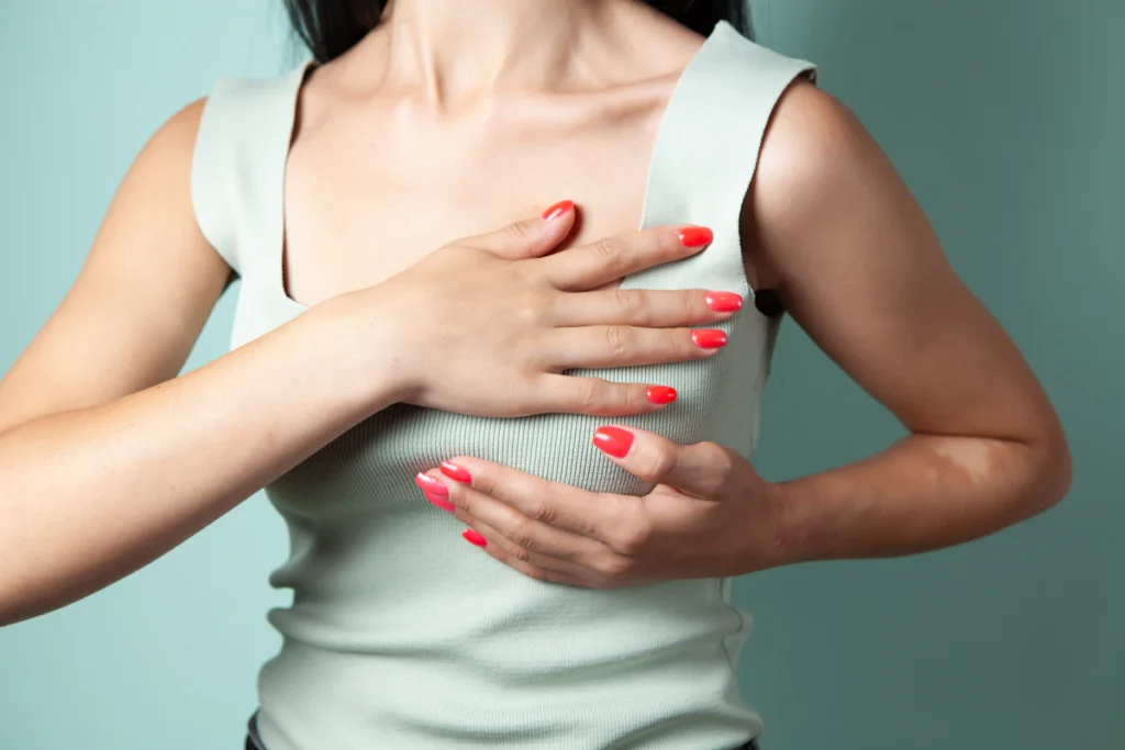 Woman with hands on chest, breast lift in Islamabad
