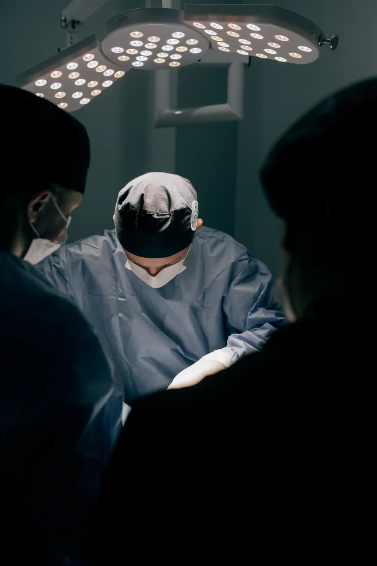 Surgeon operating under theatre lights