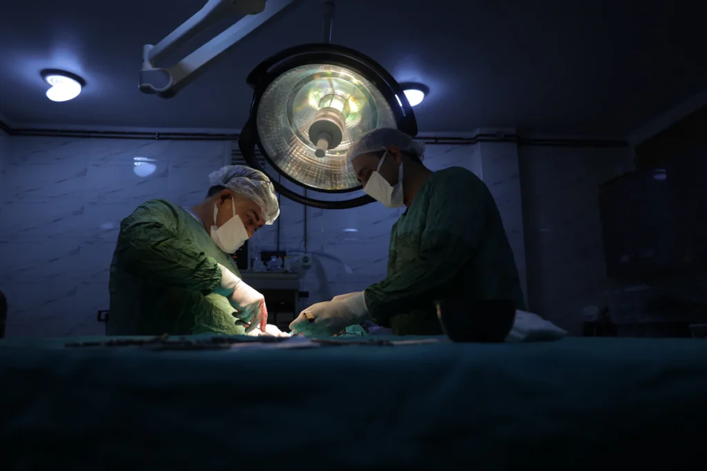 Surgeon operating in theatre