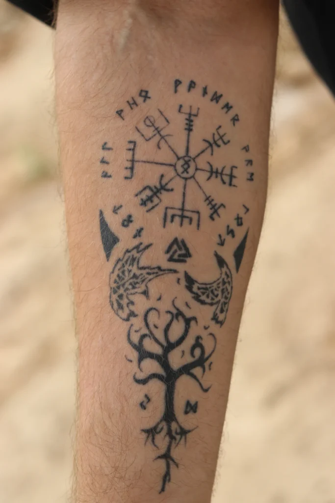 Black ink tattoo on the forearm